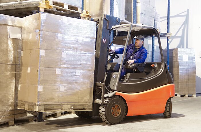 Forklift loader worker driver at warehouse